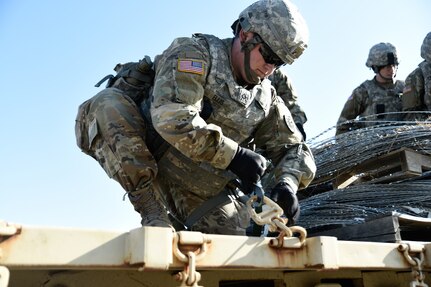 U.S. Army Pfc. Jeremiah Ellis, 7th Transportation Brigade (Expeditionary) motor transport operator, ties down a pallet of constantine wire at Joint Expeditionary Base Little Creek-Fort Story, Virginia, March 29, 2019. Teams of four Soldiers competed to load and tie down the pallet with the quickest time. Once loaded, a non-commissioned officer would inspect the pallet to ensure the load was secured to standard. (U.S. Army photo by Spc. Travis Teate)
