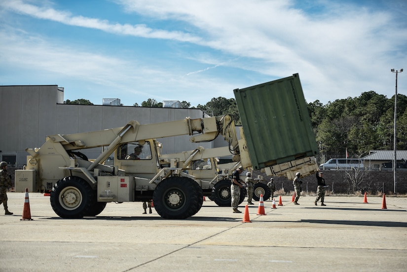 U.S. Army Soldiers assigned to the 7th Transportation Brigade (Expeditionary), prepare to compete in navigating a 5K forklift through an “S-pattern” obstacle course at Joint Expeditionary Base Little Creek-Fort Story, Virginia, March 29, 2019. Due to restricted visibility, the forklift driver relies on the direction of his ground guide to navigate.  (U.S. Army photo by Spc. Travis Teate)