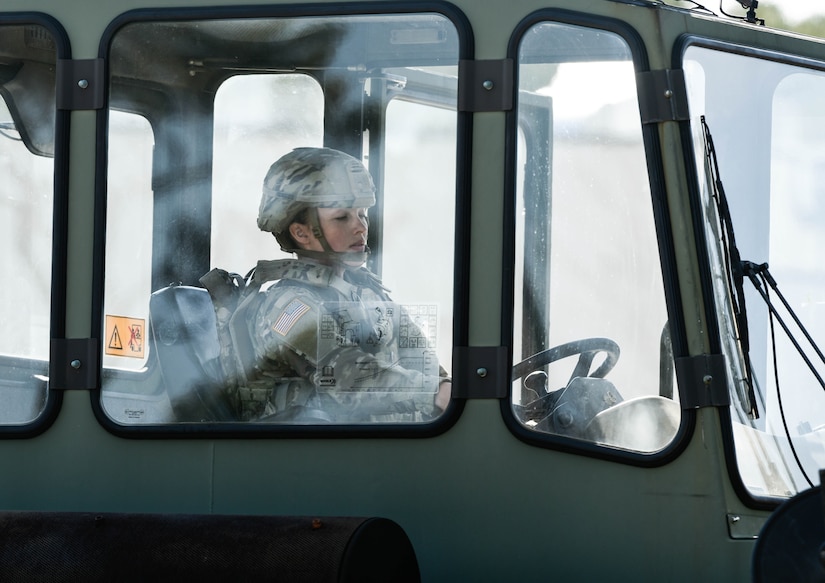 U.S. Army Pfc. Skylar Leszek, 567th Transportation Detachment, 53rd Trans. Battalion, 7th Trans. Brigade (Expeditionary) motor transport operator, pilots a forklift with a shipping container to a flatbed at Joint Expeditionary Base Little Creek-Fort Story, Virginia, March 29, 2019. Leszek was the quickest to load the 2 containers. (U.S. Army photo by Spc. Travis Teate)