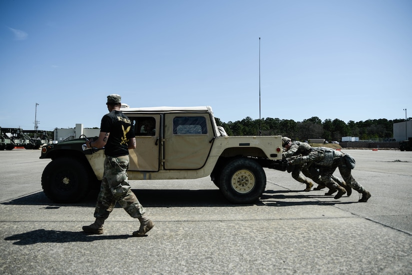 U.S. Army Soldiers assigned to the 11th Transportation Battalion, 7th Trans. Brigade (Expeditionary), compete to push a humvee 100 yards mechanically unassisted from standstill at Joint Expeditionary Base Little Creek-Fort Story, Virginia, March 29, 2019. The 11th Trans. Btn. won with the fastest time of 39.3 seconds. (U.S. Army photo by Spc. Travis Teate)