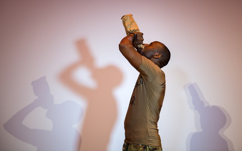 U.S. Air Force Staff Sgt. Patrick Sims, 733rd Logistics Readiness Squadron vehicle mechanic, simulates drinking alcohol while rehearsing the play ‘Everybody Knows’ at Joint Base Langley-Eustis, Virginia, April 9, 2019.