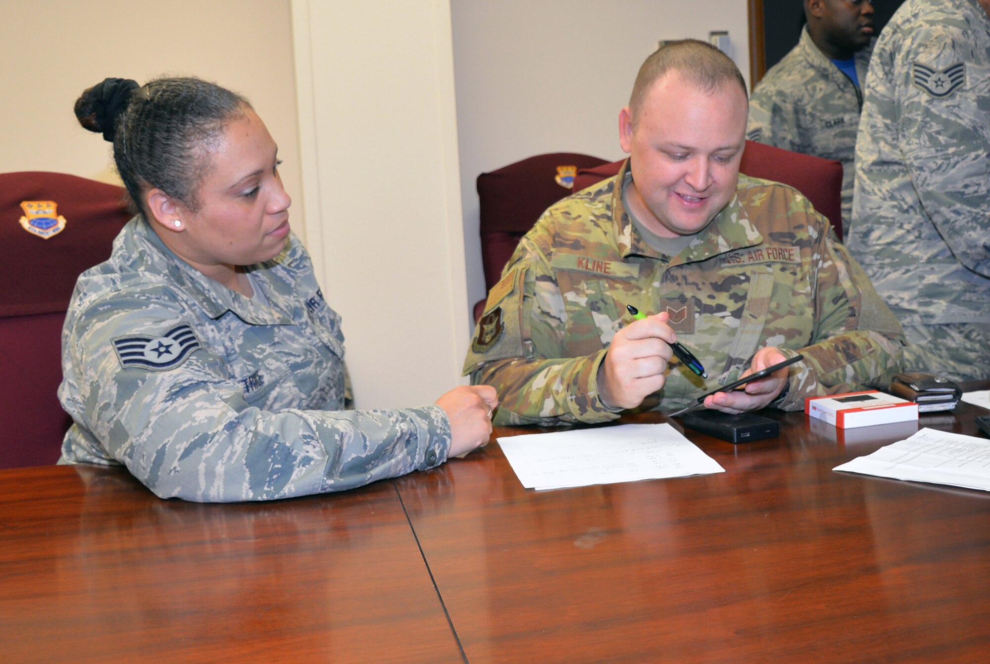 Staff Sgt. Luz Trice, 433rd Mission Support Group command support staff, guides Staff Sgt. Daryn Kline, 433rd Aircraft Maintenance Squadron avionics specialist, through the process of submitting a travel voucher by using the new mobile common access card enabled Air Force Connect app at Joint Base San Antonio-Lackland, Texas April 7, 2019.