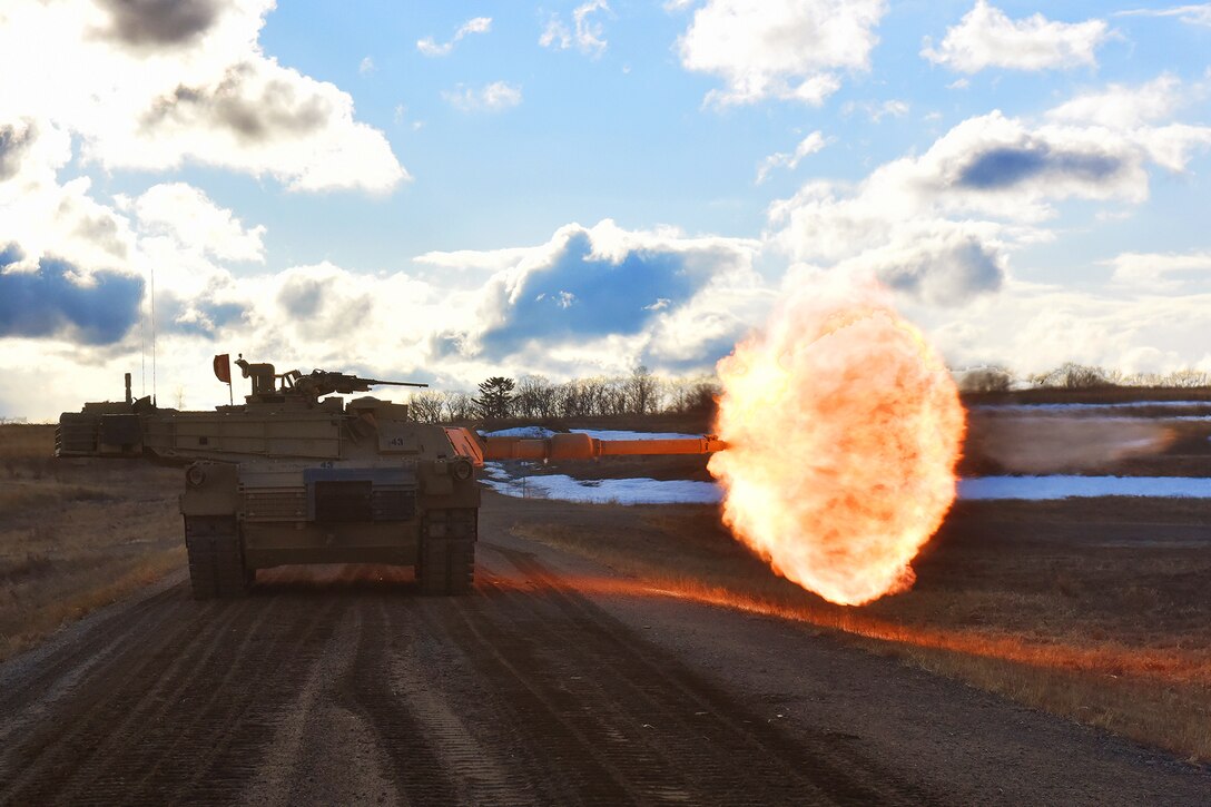 Army tank crews engage targets downrange.