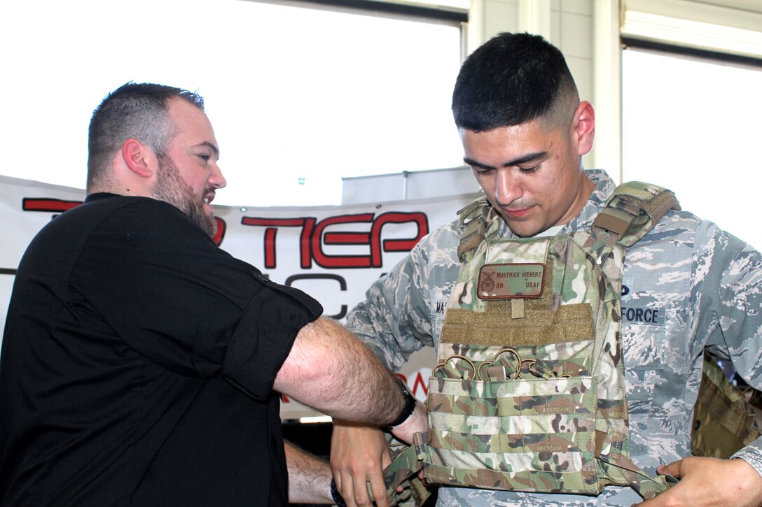 Staff Sgt. Eric Martinez tries on a quick release protection vest during Industry Day April 9, 2019, on Joint Base San Antonio-Lackland, Texas.