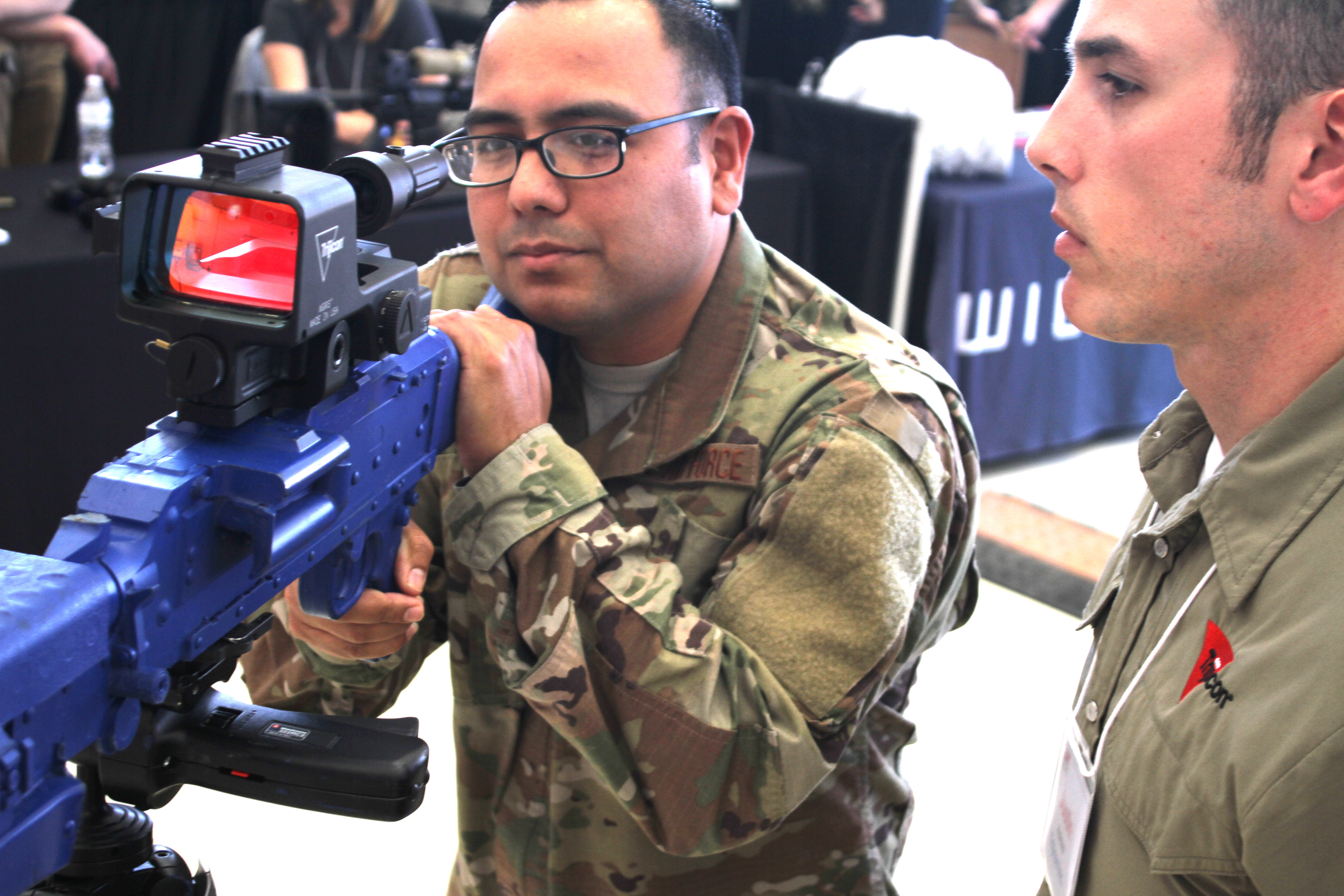 Master Sgt. Juan De La Rosa listens to a presentation on an any-light weapon aiming system at Industry Day April 9, 2019, on Joint Base San Antonio-Lackland, Texas. Several dozen vendors set up booths at the event to show installation and mission support Airmen and visiting senior Air Force leaders the latest equipment and technology available to potentially help the Air Force as it continues to defend the United States. (U.S. Air Force photo by Debbie Aragon)