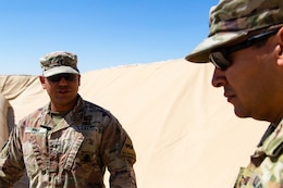 Warrant Officer Joseph Pina, 504th Quartermaster Company, 524th Support Battalion, 300th Sustainment Brigade, discusses fuel bag operations with Staff Sgt. Robert Miranda, 300th Sustainment Brigade fuel operation noncommissioned officer, at Camp Buehring, Kuwait, March 19, 2019.