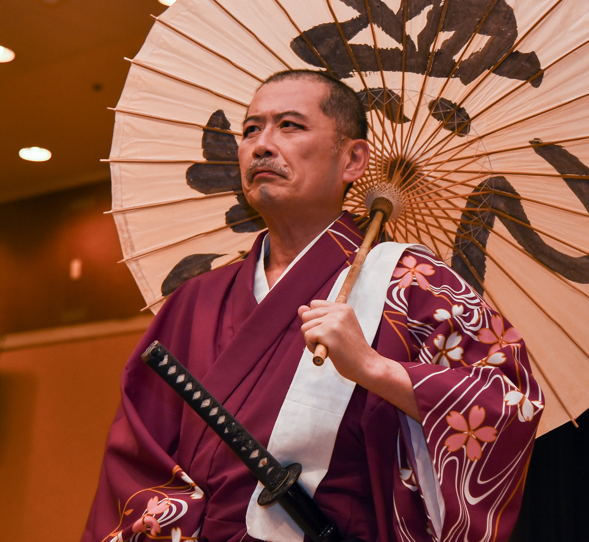 A Japanese storyteller stands in character during a traditional Japanese play at Misawa Air Base, Japan, April 6, 2019. The Japanese storytelling was a performance consisting of traditional dances, songs played with traditional instruments and acting for the 32nd Annual Japan Day, which shared Japanese culture with the base. (U.S. Air Force photo by Branden Yamada)