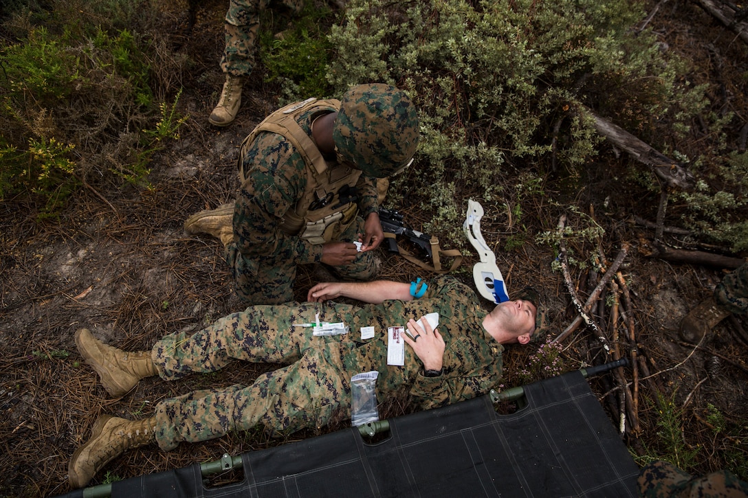 A U.S. Navy corpsman with Special Purpose Marine Air-Ground Task Force-Crisis Response-Africa 19.2, Marine Forces Europe and Africa, administers medical care to a simulated casualty during a Tactical Recovery of Aircraft and Personnel exercise in Troia, Portugal, April 5, 2019. SPMAGTF-CR-AF is deployed to conduct crisis-response and theater-security operations in Africa and promote regional stability by conducting military-to-military training exercises throughout Europe and Africa. (U.S. Marine Corps photo by Cpl. Margaret Gale)
