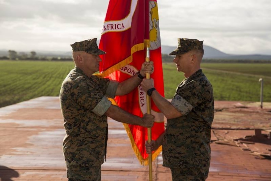 U.S. Marine Col. Thomas Dodds, left, the commanding officer of Special Purpose Marine Air-Ground Task Force-Crisis Response-Africa 19.1, transfers the unit colors to, Col. Eric Cloutier the commanding officer of SPMAGTF-CR-AF 19.2, during a transfer of authority ceremony at Morón Air Base, Spain, April 6, 2019. SPMAGTF-CR-AF is deployed to conduct crisis-response and theater-security operations in Africa and promote regional stability by conducting military-to-military training exercises throughout Europe and Africa. (U.S. Marine Corps photo by Cpl. Margaret Gale)