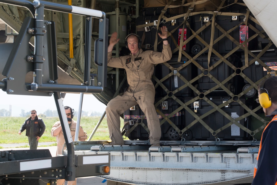 A U.S. Marine with Special Purpose Marine Air-Ground Task Force-Crisis Response-Africa prepares to unload cargo from a U.S. Marine KC-130J Super Hercules at Naval Air Station Sigonella, Italy, April 6, 2019. The aircraft transported Marines and equipment with the aviation combat element for SPMAGTF-CR-AF 19.2, whose mission is to provide an autonomous, self-deploying, and highly mobile crisis response force to U.S. AFRICOM. (U.S. Marine Corps photo by Staff Sgt. Mark E Morrow Jr)