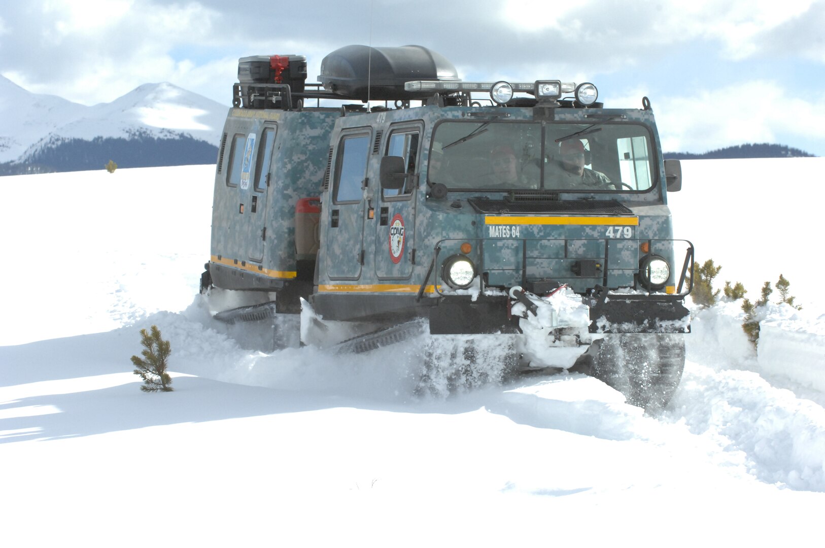 An M973A1 Small Unit Support Vehicle, aka SUSV, clad in emergency lights and digital camouflage, claws its way through the snow at Taylor Park Reservoir near Gunnison, Colo., March 15, 2010. The SUSV, which is capable of traversing almost any terrain, is the primary vehicle used by the Colorado Army National Guard’s Snow Response Team. Such vehicles are on standby if needed during the latest storm.