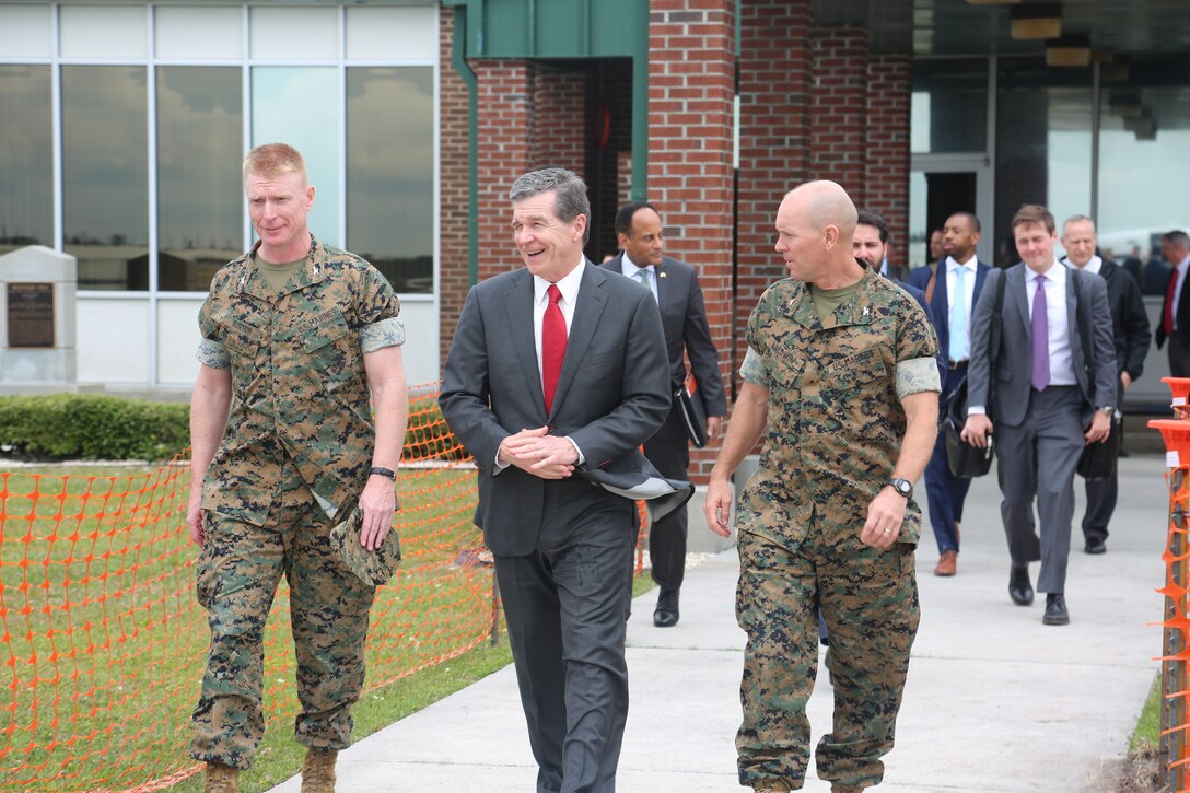 Roy Cooper, North Carolina governor speaks with Col. Russell C. Burton, commanding officer of Marine Corps Air Station New River and Col. Scott A. Baldwin, deputy commander of MCIEAST-MCB Camp Lejeune, during a tour of the installation and buildings damaged by Hurricane Florence at MCAS New River, N.C., April 9, 2019. This is Cooper’s initial command visit to Marine Corps Base Camp Lejeune and MCAS New River as Governor of North Carolina. During his tour Cooper met with senior leaders of both installations and saw first-hand the damage left by Hurricane Florence. (U.S. Marine Corps photos by Cpl. Jonathan Sosner)