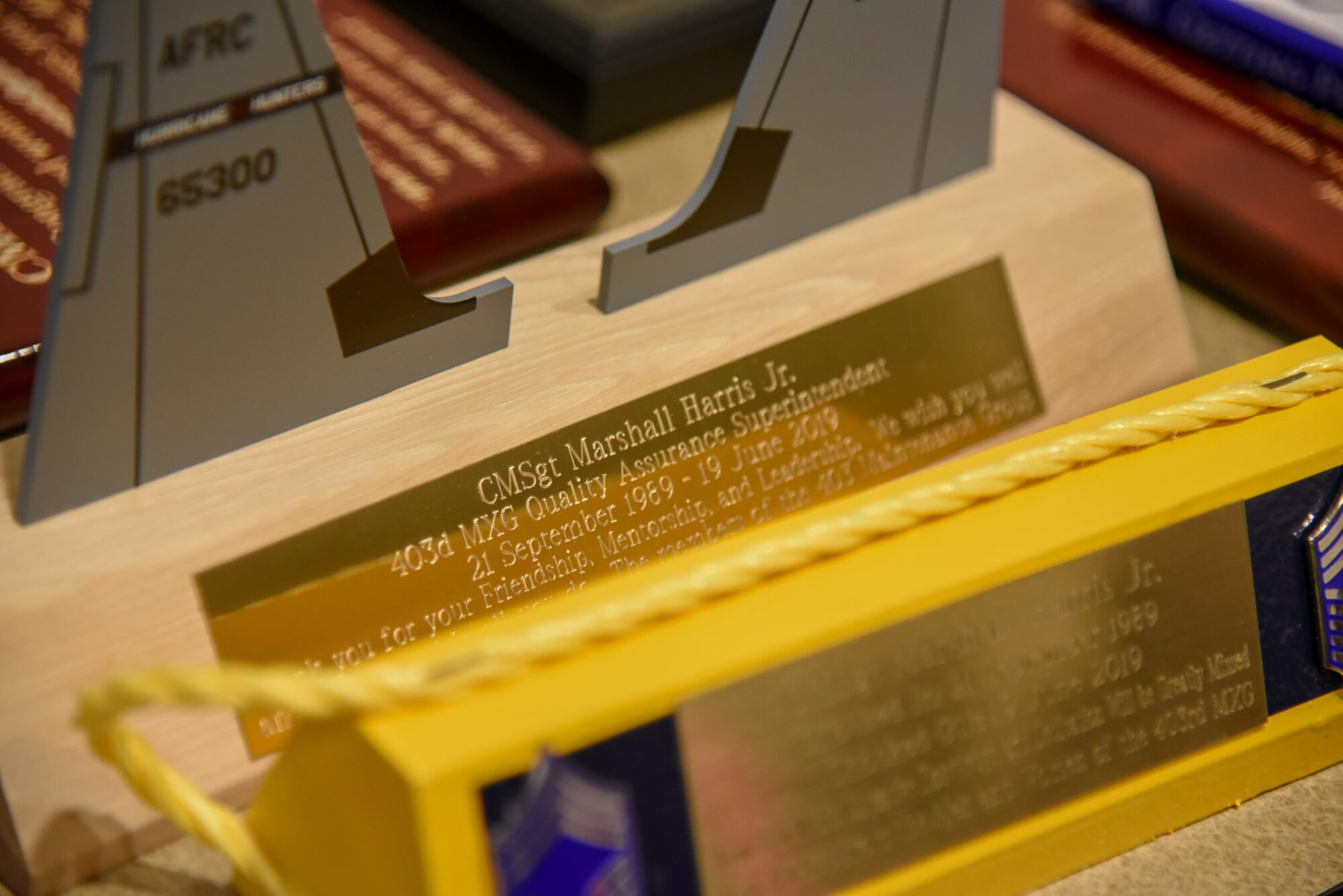 Various gifts and mementos honoring the career of Chief Master Sgt. Marshall O. Harris Jr., 403rd Maintenance Group quality assurance superintendent, sit upon a table at Roberts Maintenance Facility April 6, 2019. In his 34-year career Harris worked with on multiple different aircraft, he also was the crew chief over two of his own. (U.S. Air Force photo by Senior Airman Kristen Pittman)