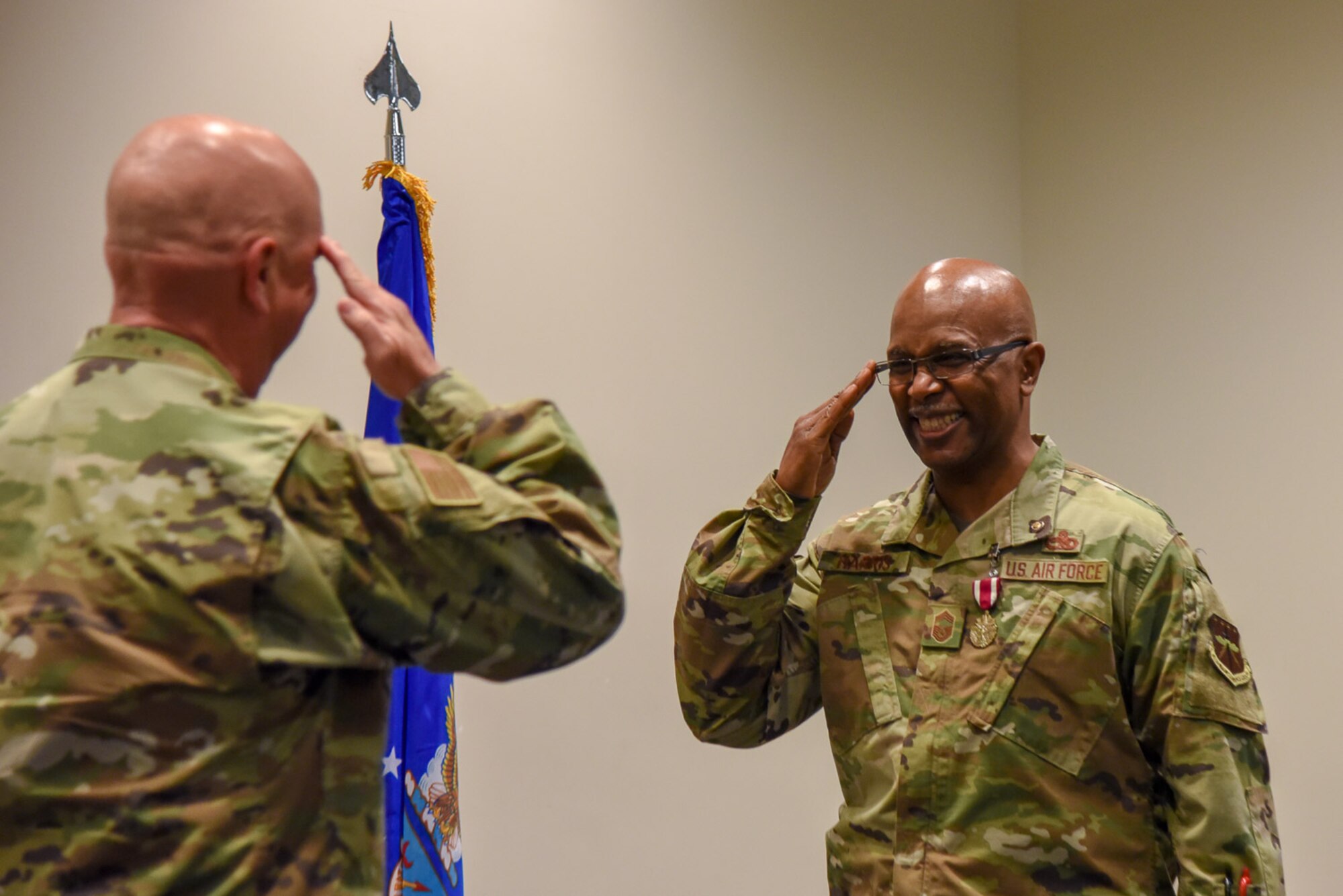 Chief Master Sgt. Marshall O. Harris Jr., 403rd Maintenance Group quality assurance superintendent at Keesler Air Force Base, Miss., salutes Col. Jay Johnson, 403rd MSG commander, after receiving a coin during his retirement ceremony at Roberts Maintenance Facility April 6, 2019. (U.S. Air Force photo by Senior Airman Kristen Pittman)