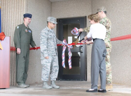 Key leaders from the 552nd Air Control Wing cut the ribbon, officially reopening the newly expanded Sensitive Compartmented Information Facility. Included in the ribbon-cutting were from left, Lt. Col. Adam Shelton, 552nd Operation Support Squadron commander; Maj. Eric Ornelas, 552nd OSS senior intelligence officer; Toni Greenfield, Chief, Special Security Office and Col. Geoffrey Weiss, 552nd ACW commander. (U.S. Air Force photo/2nd Lt. Ashlyn K. Paulson)