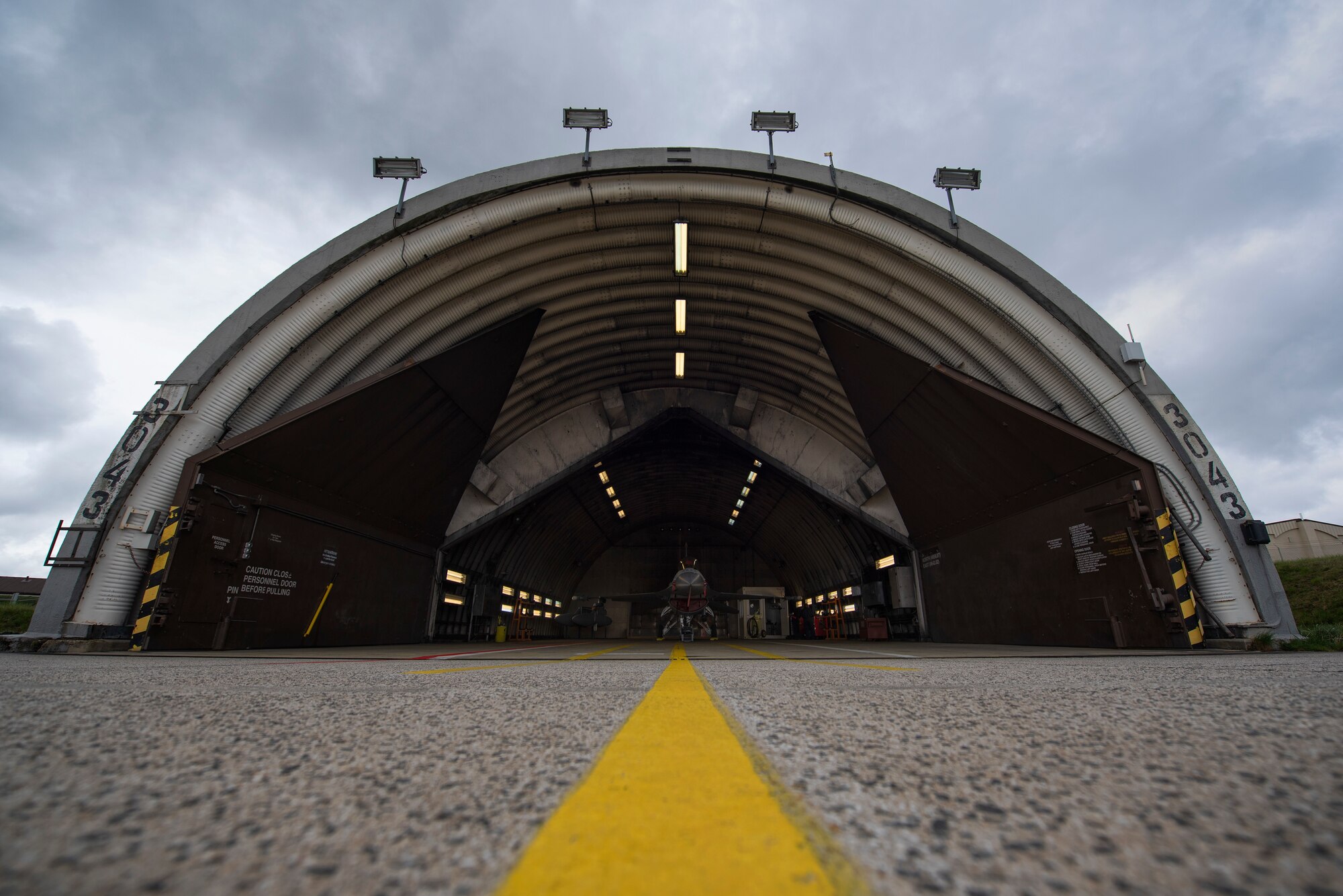 A U.S. Air Force F-16 Fighting Falcon assigned to the 480th Fighter Squadron sits in a hardened aircraft shelter at Spangdahlem Air Base, Germany, April 3, 2019. The F-16 is a highly maneuverable multi-role fighter aircraft used to support Spangdahlem's mission of airpower deterrence and readiness. (U.S. Air Force photo by Airman 1st Class Valerie Seelye)