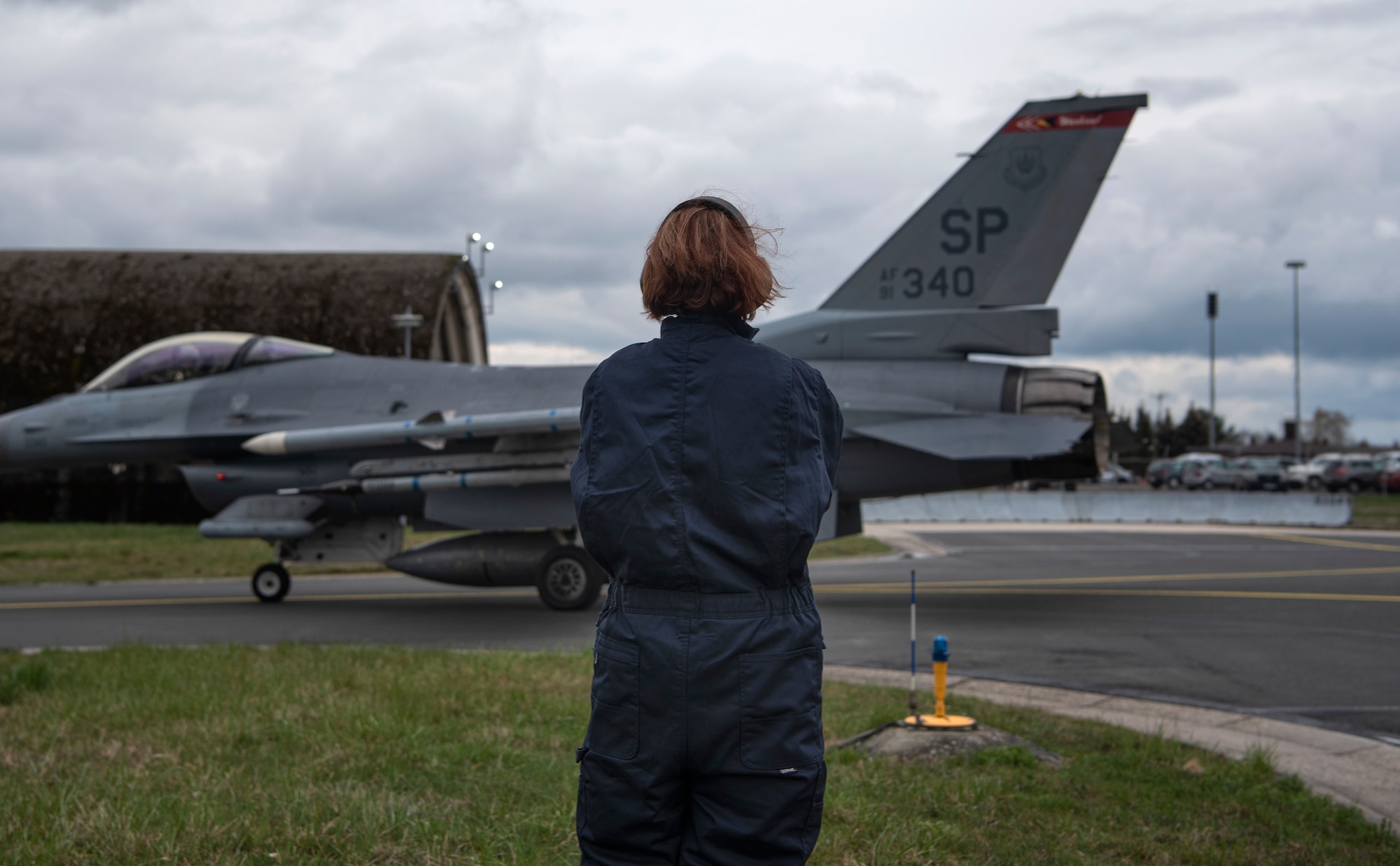 U.S. Air Force Staff Sgt. Stephanie Gillie, 52nd Security Forces Squadron investigator, watches an F-16 Fighting Falcon taxi at Spangdahlem Air Base, Germany, April 3, 2019. Gillie volunteered to participate in the 52nd Aircraft Maintenance Squadron Crew Chief for a Day program for a better understanding of flightline operations. She had never been on a flightline or near fighter jets before this opportunity. (U.S. Air Force photo by Airman 1st Class Valerie Seelye)