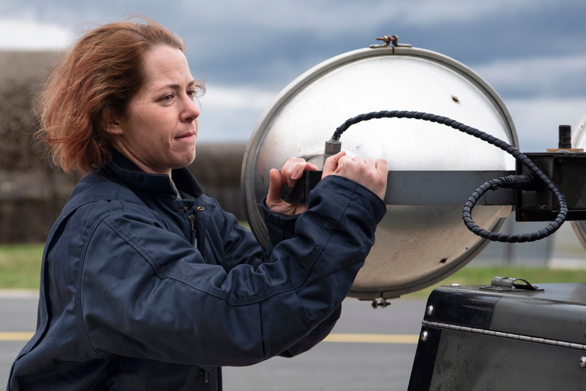 U.S. Air Force Staff Sgt. Stephanie Gillie, 52nd Security Forces Squadron investigator, moves a light-all at Spangdahlem Air Base, Germany, April 3, 2019. Gillie volunteered to work on the flightline as part of the 52nd Aircraft Maintenance Squadron Crew Chief for a Day program. The program helps Airmen unfamiliar with flightline operations understand their tie to Spangdahlem's mission of airpower deterrence and readiness. (U.S. Air Force photo by Airman 1st Class Valerie Seelye)