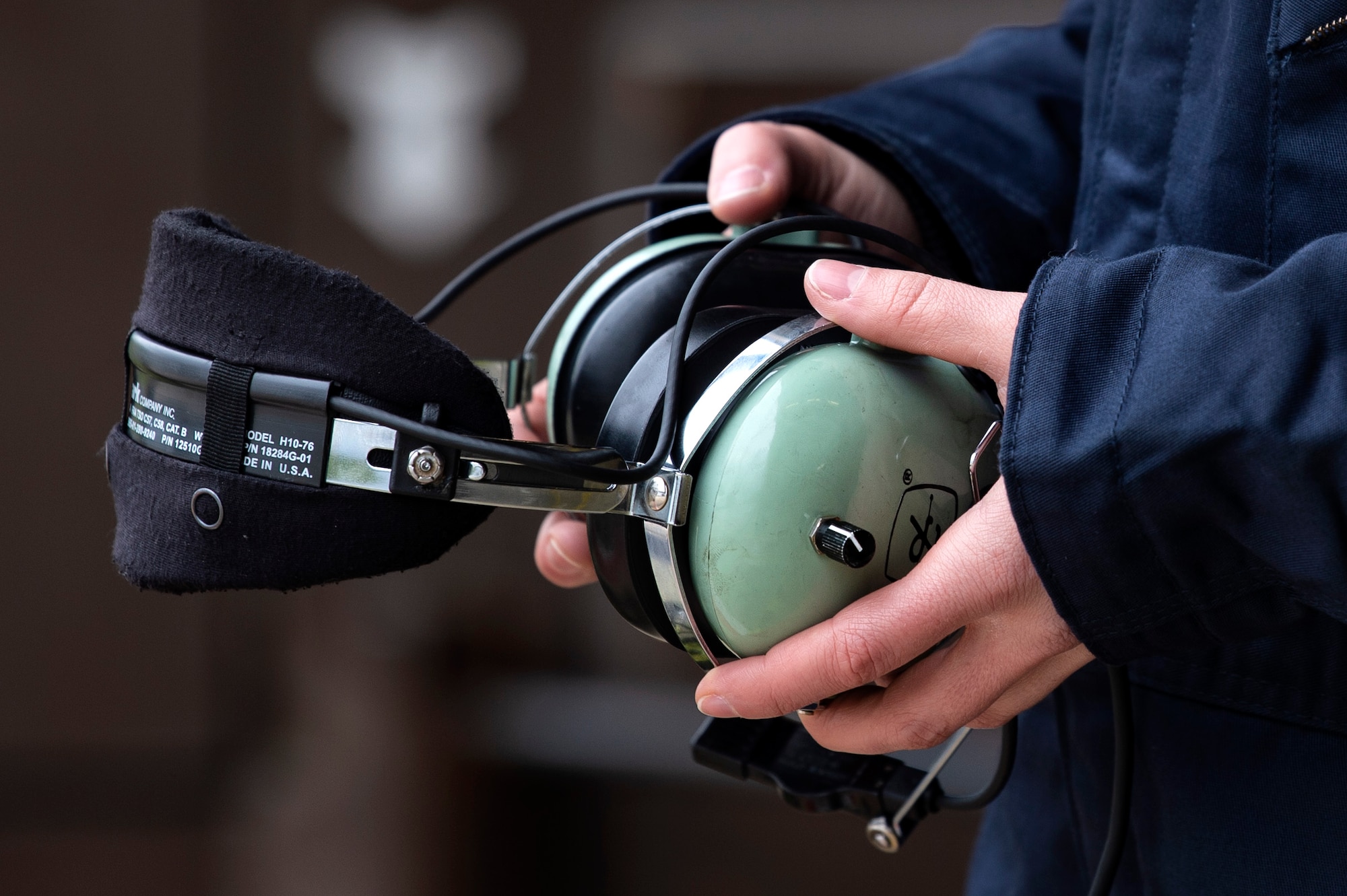 U.S. Air Force Staff Sgt. Stephanie Gillie, 52nd Security Forces Squadron investigator, holds a headset at Spangdahlem Air Base, Germany, April 3, 2019. Gillie volunteered to work on the flightline as part of the 52nd Aircraft Maintenance Squadron Crew Chief for a Day program. She helped with the launch and recovery of jets and used the headset to observe how pilots and crew chiefs communicate. (U.S. Air Force photo by Airman 1st Class Valerie Seelye)