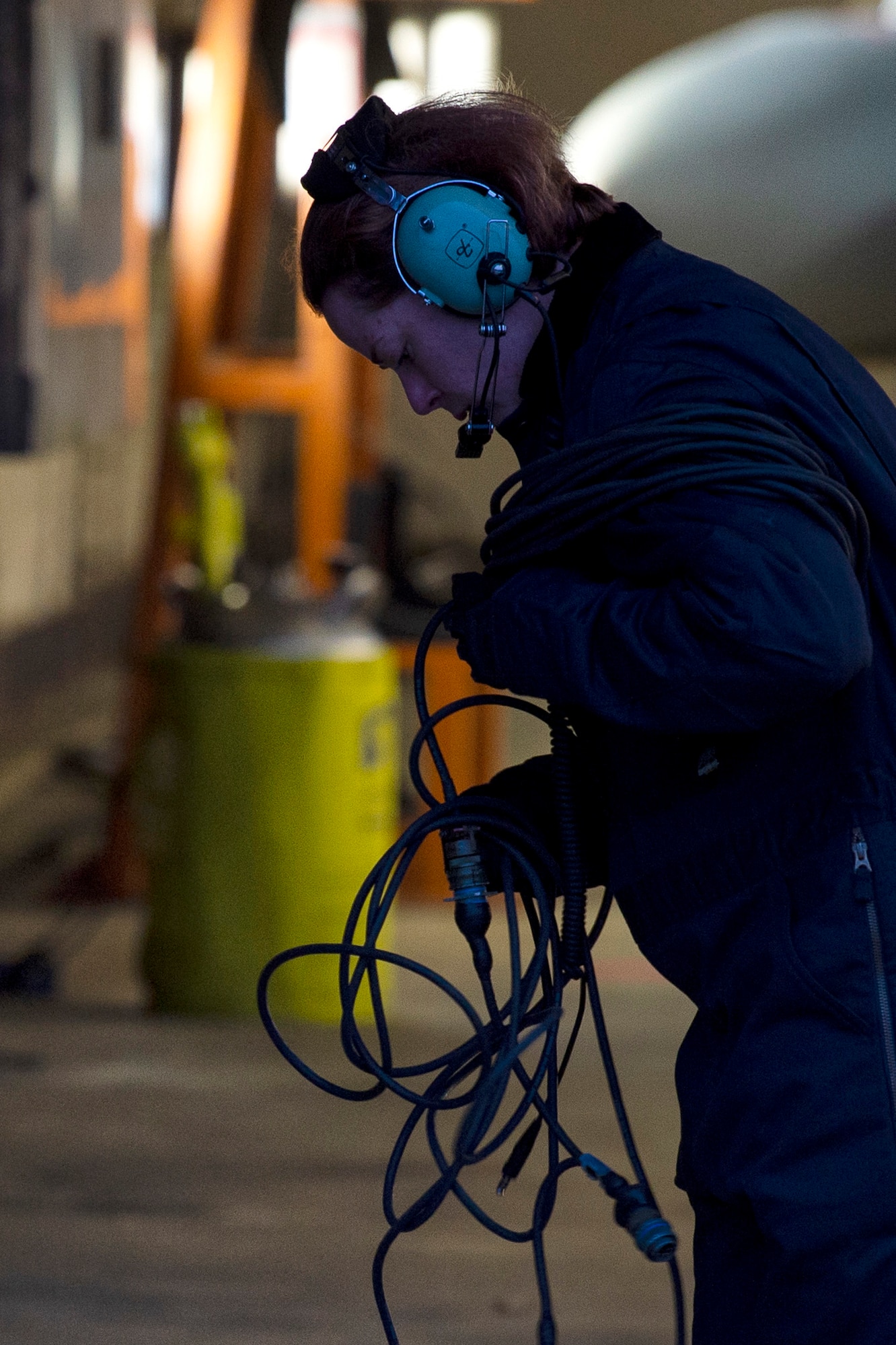 U.S. Air Force Staff Sgt. Stephanie Gillie, 52nd Security Forces Squadron investigator, winds up a cable at Spangdahlem Air Base, Germany, April 3, 2019. Gillie worked on the flightline as part of the 52nd Aircraft Maintenance Squadron Crew Chief for a Day program. Gillie observed and helped with the launch and recovery of aircraft, inspections, and learned how maintainers interact with pilots. The new, weekly program is designed to give Airmen an understanding of flightline operations. (U.S. Air Force photo by Airman 1st Class Valerie Seelye)