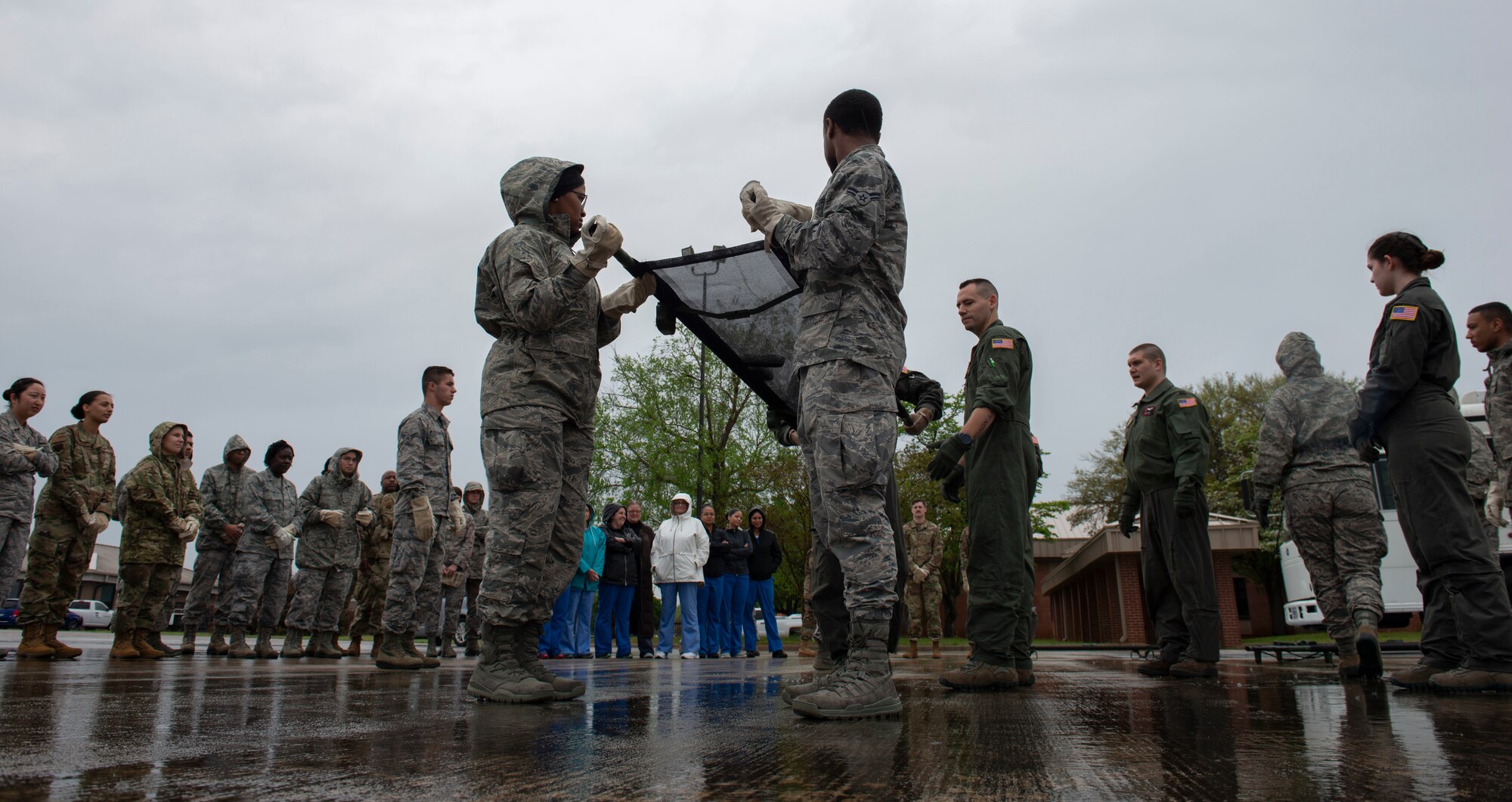 U.S. Airmen assigned to the 20th Medical Group lift a stretcher in a formation of four during a training exercise at Shaw Air Force Base, S.C., April 9, 2019.