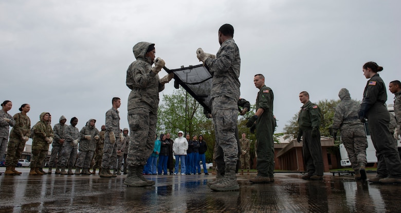 U.S. Airmen assigned to the 20th Medical Group lift a stretcher in a formation of four during a training exercise at Shaw Air Force Base, S.C., April 9, 2019.