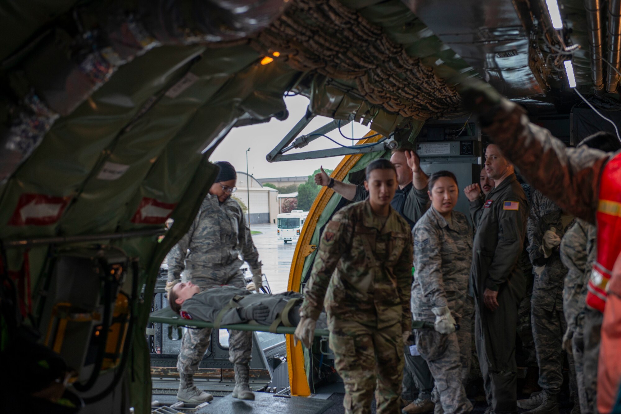 U.S. Airmen assigned to the 20th Medical Group (MDG) carry a simulated patient onto a U.S. Air Force KC-135 Stratotanker to practice loading ambulatory patients onto aircraft at Shaw Air Force Base, S.C., April 9, 2019.