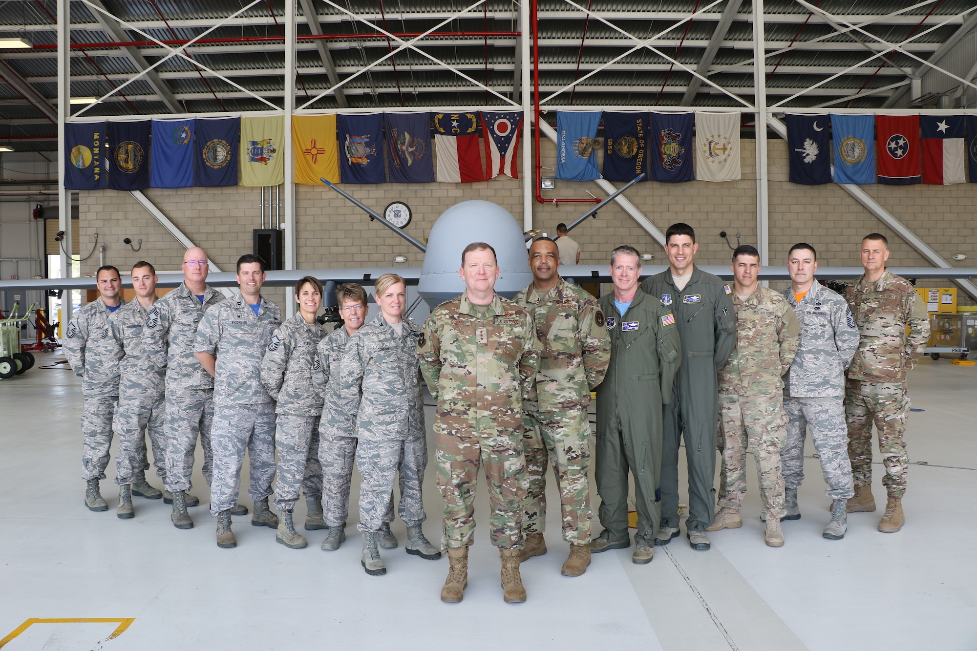 Members from the 163rd Attack Wing, California Air National Guard, March Air Reserve Base, pose for a photo in front of an MQ-9 Reaper remotely piloted aircraft here with leaders from the 452nd Air Mobility Wing and U.S. Air Force Lt. Gen. Richard Scobee, commander of Air Force Reserve Command, and U.S. Air Force Chief Master Sgt. Timothy White, AFRC command chief, on April 6, 2019. AFRC senior leadership toured March ARB to learn about the 452nd AMW’s mission, capabilities and challenges as part of a three-day unit visit.