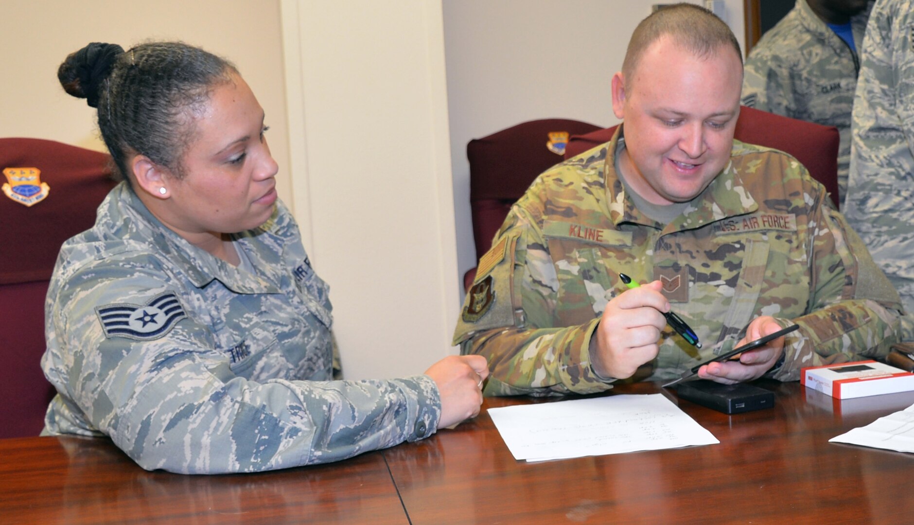 Staff Sgt. Luz Trice, 433rd Mission Support Group command support staff, guides Staff Sgt. Daryn Kline, 433rd Aircraft Maintenance Squadron avionics specialist, through the process of submitting a travel voucher by using the new mobile common access card enabled Air Force Connect app at Joint Base San Antonio-Lackland April 7. The 433rd Airlift Wing is one of two beta testing locations for this new capability.