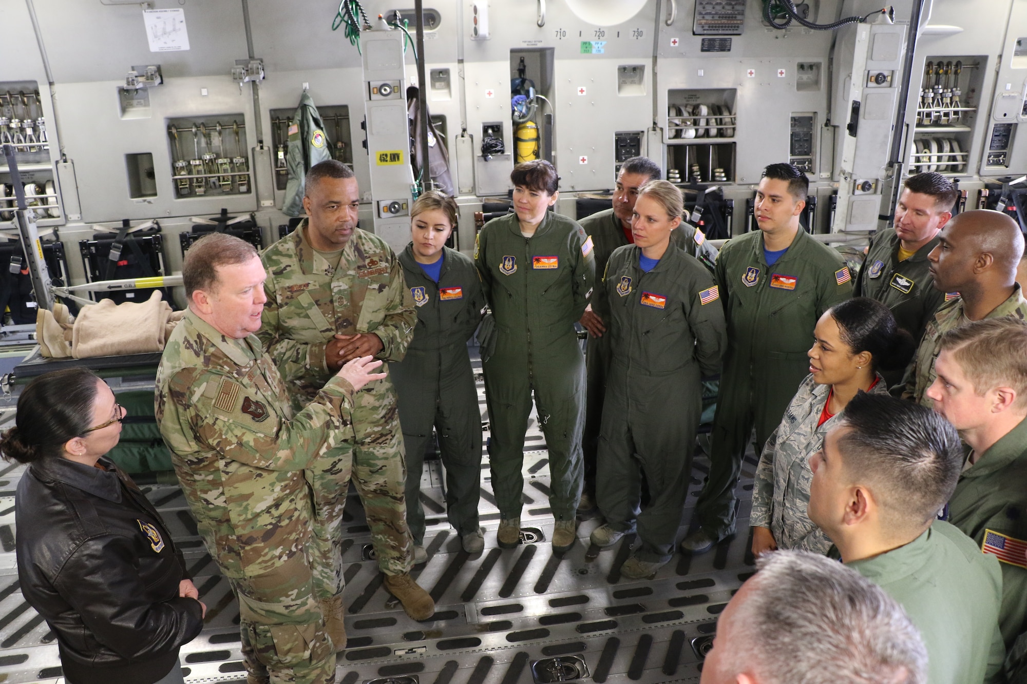 U.S. Air Force Lt. Gen. Richard Scobee, commander of Air Force Reserve Command, and U.S. Air Force Chief Master Sgt. Timothy White, AFRC command chief, speak with members from the 452nd Aeromedical Evacuation Squadron aboard a C-17 Globemaster III on the flight line here April 6, 2019. AFRC senior leadership toured March ARB to learn about the 452nd AMW’s mission, capabilities and challenges as part of a three-day unit visit.