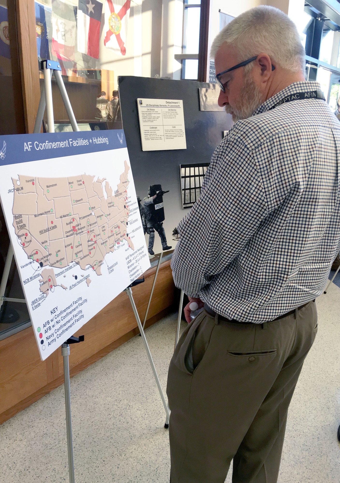 Joe Hart of the Air Force Civil Engineer Center views a security forces display in the lobby of the Pfingston BMT Reception Center at Joint Base San Antonio-Lackland during a break in the Installation and Mission Support Weapons and Tactics Conference outbriefs April 10.