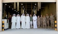 300th Sustainment Brigade Soldiers stand with members of the Kuwait Criminal Investigation Division during a tour of the Joint Military Mail Terminal at Camp Arifjan, Kuwait, March 7, 2019.