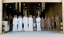 300th Sustainment Brigade Soldiers stand with members of the Kuwait Criminal Investigation Division during a tour of the Joint Military Mail Terminal at Camp Arifjan, Kuwait, March 7, 2019.