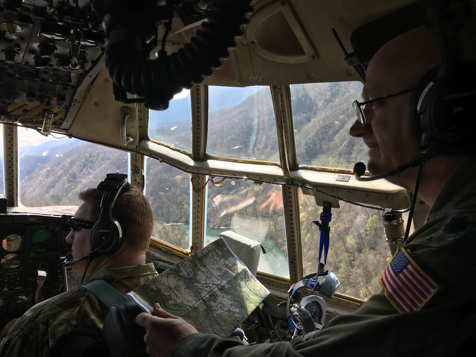 Lt. Col. Barry “JR” Cupples, a navigator with the 757th Airlift Squadron, looks through the flight deck windows of a C-130H Hercules aircraft during the flight in which he completed his ten thousandth C-130 flight hour, April 6, 2019.