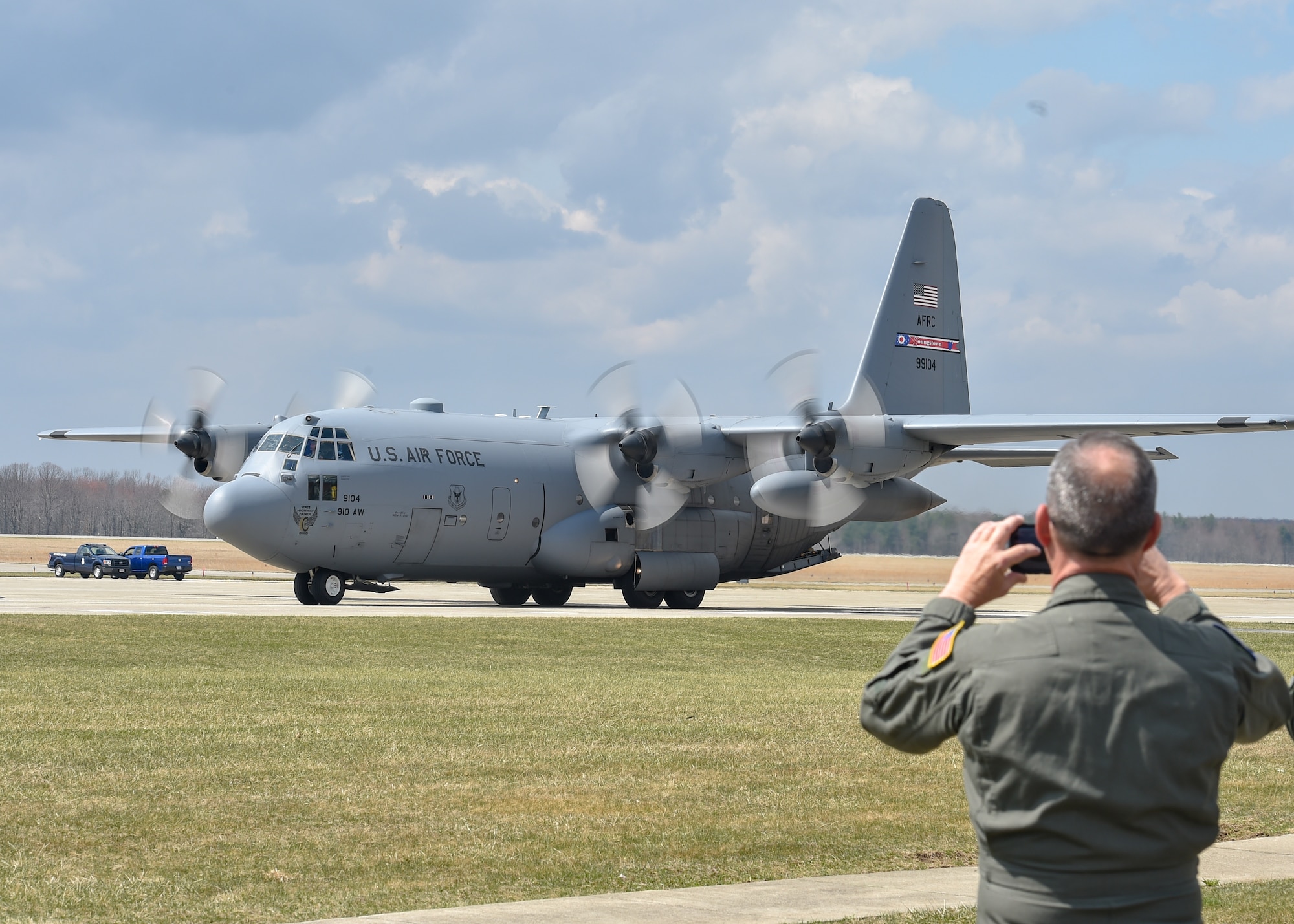 A Reserve Citizen Airman assigned to the 757th Airlift Squadron watches a C-130H Hercules aircraft taxi to its parking spot here, April 6, 2019.