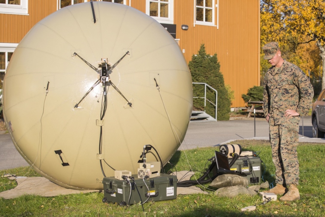 U.S. Marine Corps Lance Cpl. Jeffrey Washburn, with 2nd Radio Battalion, II Marine Expeditionary Force Information Group sets up an Odin’s Sphere in order to have satellite communications during Exercise Trident Juncture 2018 at Vaernes Air Station, Norway, Oct. 12, 2018. Trident Juncture 2018 enhances the U.S. and NATO Allies' and partners' abilities to work together collectively to conduct military operations under challenging conditions. (U.S. Marine Corps photo by Lance Cpl. Tanner Seims)