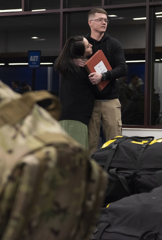 Senior Airman Eric Swicegood, 50th Security Forces Squadron response force member, embraces his wife while waiting to depart for his deployment at the Colorado Springs Airport, Colorado Springs, Colorado, April 8, 2019. Security Forces Airmen are experts in providing support in base defense and airfield operations through offensive and defensive postures, quick response force capabilities and fly away security teams. (U.S. Air Force photo by Staff Sgt. Matthew Coleman-Foster)