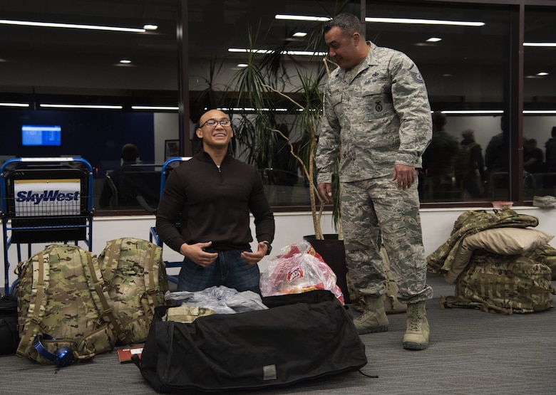 Senior Airman Tristan Ecalnea, 50th Security Forces Squadron response force member, laughs with Master Sgt. Michael DeGennaro, 50th SFS flight chief, while packing away personal items at the Colorado Springs Airport, Colorado Springs, Colorado, April 8, 2019. Security Forces Airmen go through extensive and innovative training in law enforcement and combat tactics to ensure success in executing today’s operations. (U.S. Air Force photo by Staff Sgt. Matthew Coleman-Foster)