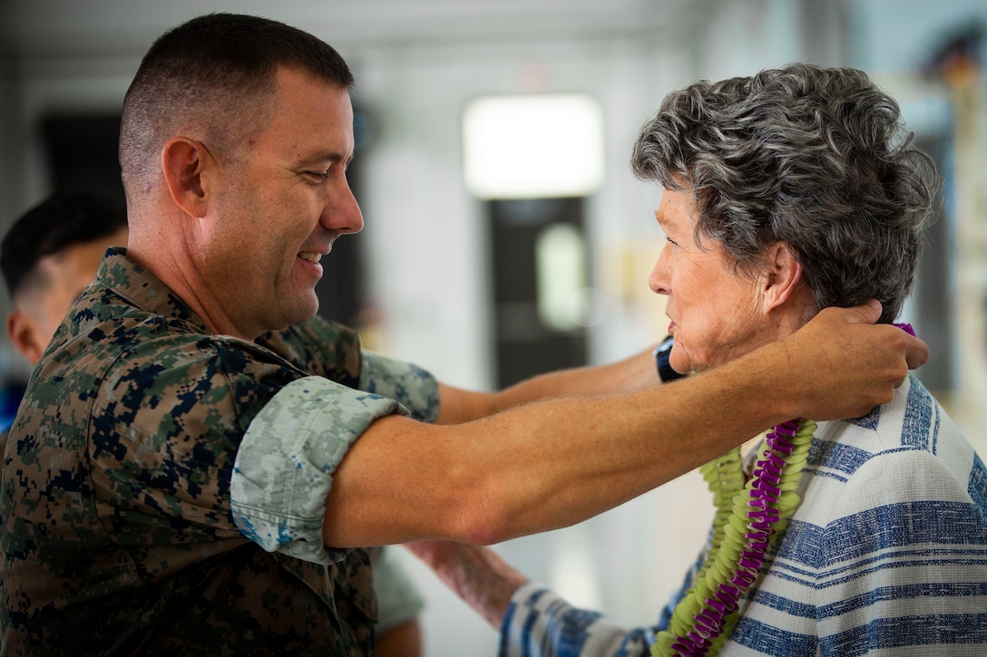 U.S. Marine Corps Lt. Col. Brian Clifton, left, commanding officer, Marine Medium Tiltrotor Squadron (VMM) 363, presents Cynthia Thielen, right, Hawaii State Representative, with a lei during VMM 363's hangar dedication ceremony, Marine Corps Air Station Kaneohe Bay, Marine Corps Base Hawaii, Sept. 21, 2018.