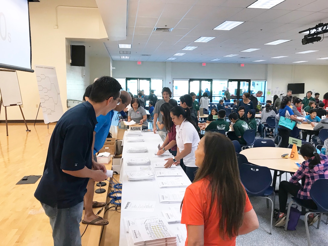 HONOLULU, Hawaii (Feb. 9, 2019) -- Honolulu District employee volunteers gather and sort student test sheets during the 2019 MATHCOUNTS Oahu competition held at the Kamehameha Schools  Feb. 9. Sixth, seventh and eighth graders from 27 Oahu public and private schools participated in the competition. MATHCOUNTS builds skills, promotes strategic problem solving and challenges students to sharpen their analytical abilities in a lively exchange of mathematical ideas through competition.  Honolulu District has actively supported this outreach activity for the past 21 years.  The winners of this competition advanced to the state level competition held March 9 at Kamehameha Schools for a chance to represent the State of Hawaii in May at the national finals in Orlando, Fla.  Honolulu District employees will also be volunteering their time as proctors and scorers for the state competition.
