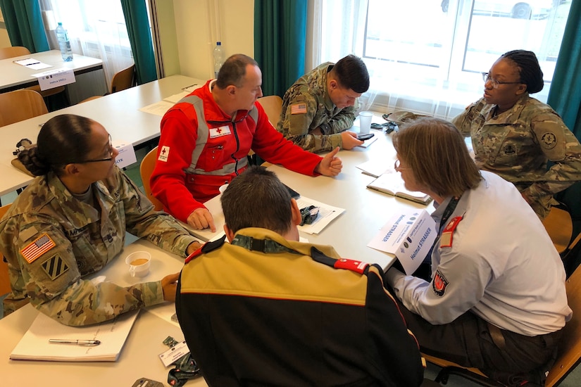 Six individuals meet at a table.