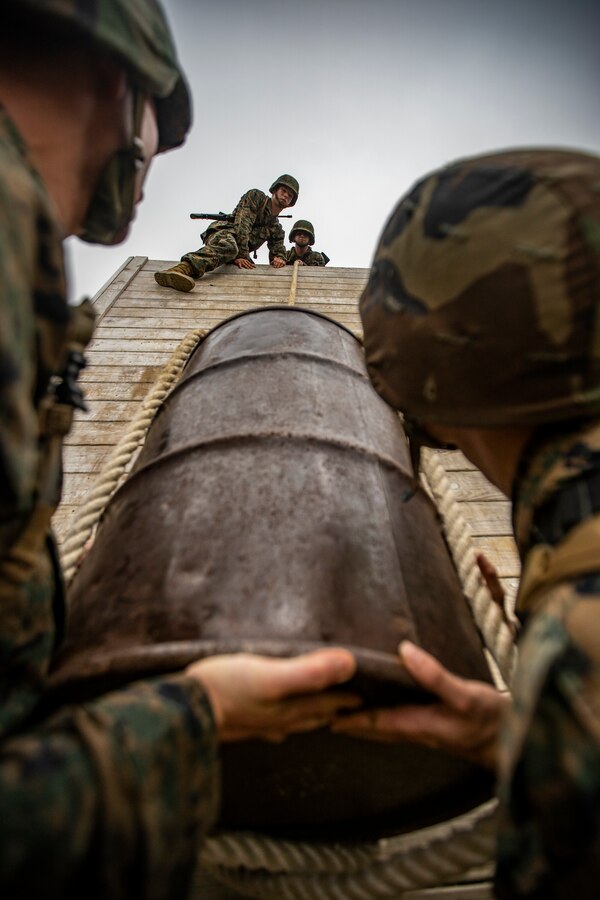 Naval Reserve Officers Training Corps Midshipmen from Tulane University and Southern University and A&M College, pulls a barrel up a wall during a leadership reaction course at Camp Shelby in Hattiesburg, Miss., April 6, 2019. Marines with Marine Forces Reserve assisted in the LRCs to provide experience and insight for midshipmen to better prepare them for Officer Candidate School and for their future military careers. (U.S. Marine Corps photo by Sgt. Andy O. Martinez)