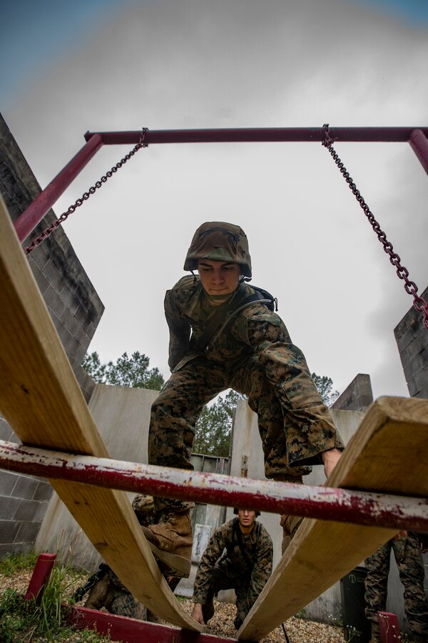 A Naval Reserve Officers Training Corps Midshipmen from Tulane University and Southern University and A&M College, walks on two wooden boards to get over an obstacle during a leadership reaction course at Camp Shelby in Hattiesburg, Miss., April 6, 2019. Marines with Marine Forces Reserve assisted in the LRCs to provide experience and insight for midshipmen to better prepare them for Officer Candidate School and for their future military careers. (U.S. Marine Corps photo by Sgt. Andy O. Martinez)