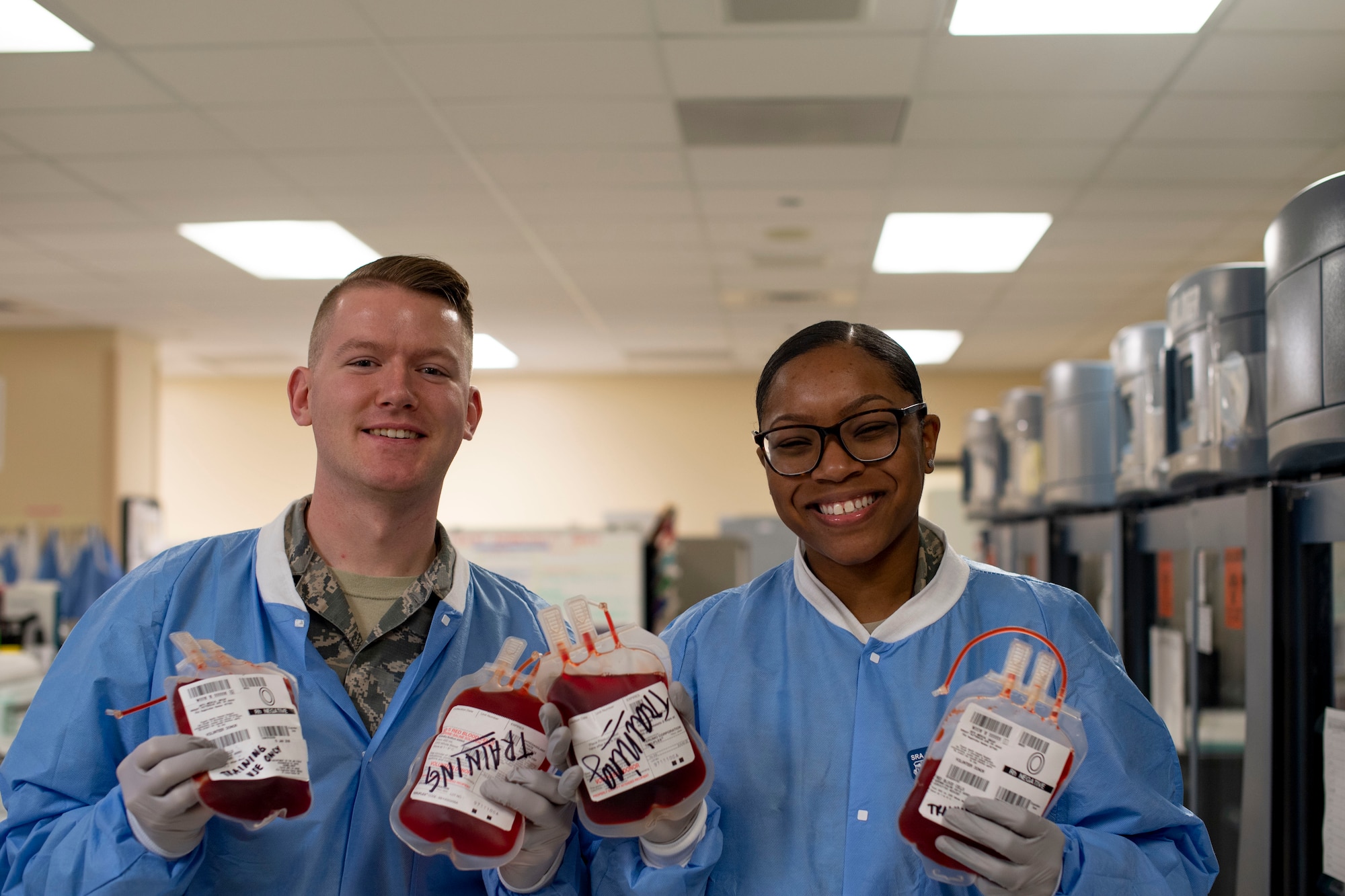 U.S. Air Force Senior Airman Jacob Lee, left, and Senior Airman Jade Cairns, both 60th Medical and Diagnostics Therapeutic Squadron Transfusion Services technicians, pose for a photo April 4, 2019, at Travis Air Force Base, California. David Grant USAF Medical Center operates the Air Force’s larges clinical laboratory, supporting 465 health care providers and 325,000 patients per year. Technicians perform 1.2 million tests annually in chemistry, special chemistry, hematology, coagulation, immunology, microbiology, point-of-care testing, histology, cytology and transfusion services. (U.S. Air Force photo by Airman 1st Class Jonathon Carnell)