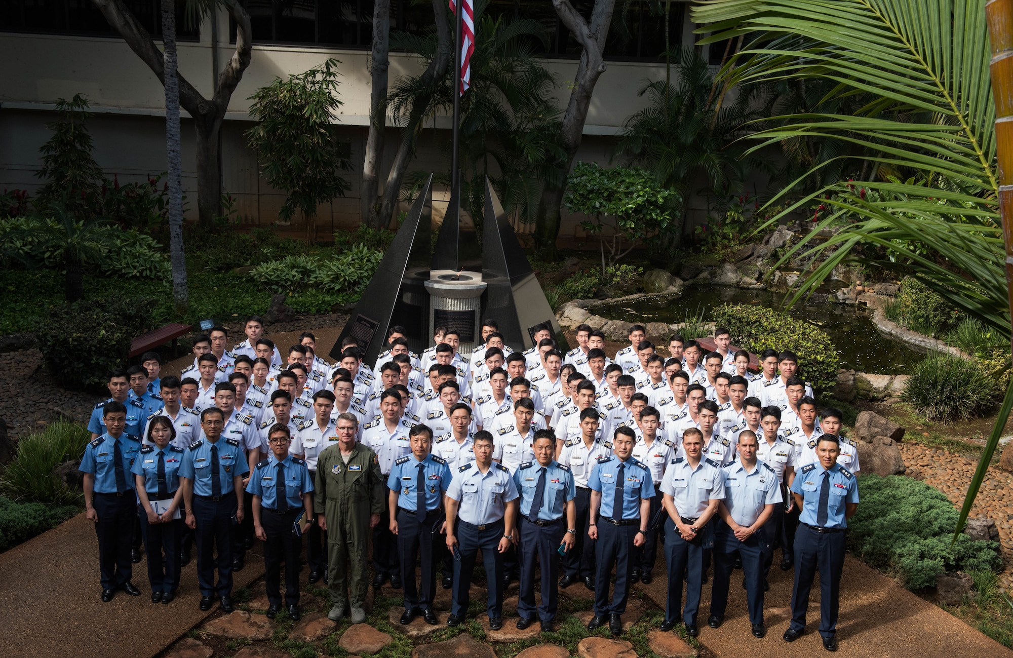 A group of Republic of Korea Air Force Academy cadets take a group photo with United States Air Force personnel in the Courtyard of Heroes during a visit to Headquarters Pacific Air Forces, Joint Base Pearl Harbor-Hickam, Hawaii, Apr. 2, 2019.