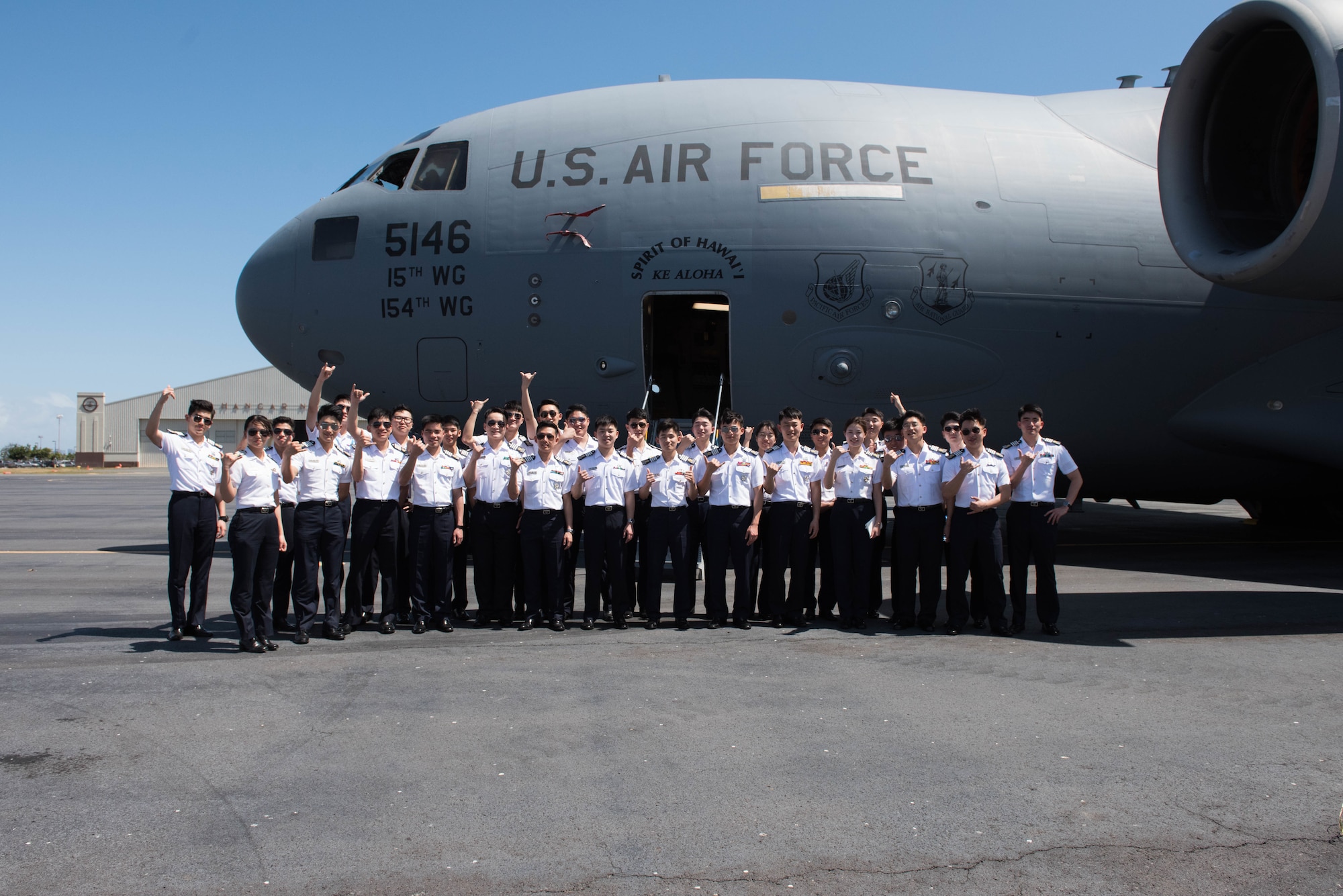 A group of Republic of Korea Air Force academy cadets take a group photo in front of a United States Hawaii Air National Guard C-17 Globemaster III during a visit to Joint Base Pearl Harbor-Hickam, Hawaii, Apr. 2, 2019.