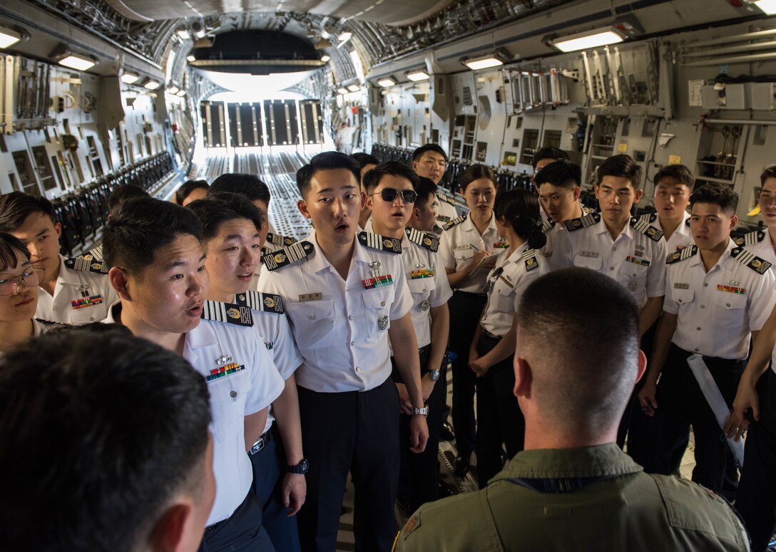A group of Republic of Korea Air Force academy cadets learn more about a United States Hawaii Air National Guard C-17 Globemaster III during a visit to Joint Base Pearl Harbor-Hickam, Hawaii, Apr. 2, 2019.