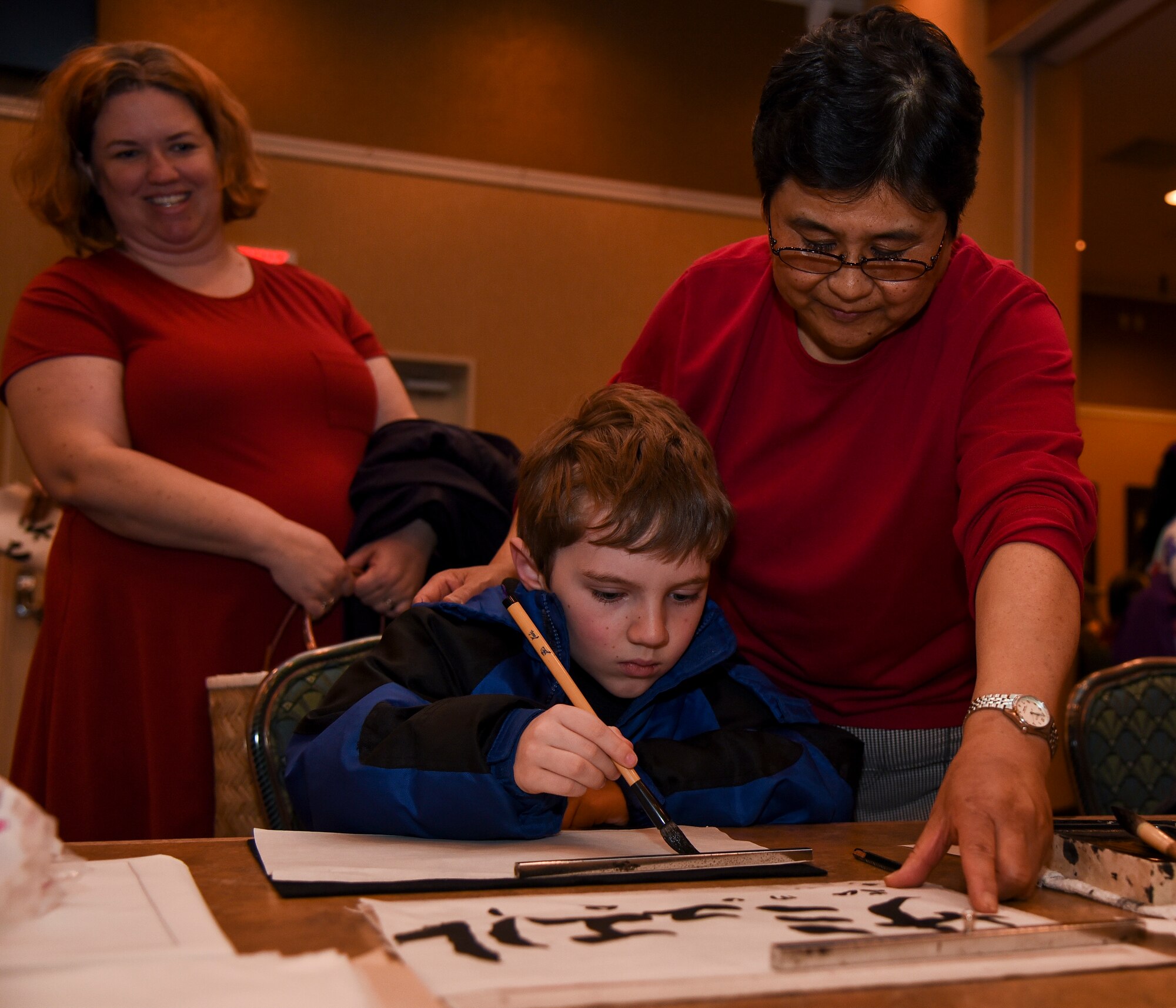 A Japan Day attendee writes his name in “katakana” during an art class during the 32nd Annual Japan Day festival at Misawa Air Base, Japan, April 6, 2019. Japanese calligraphy is the ancient Japanese practice of artistic hand writing. “Katakana” characters are commonly used for words from foreign languages. (U.S. Air Force photo by Branden Yamada)