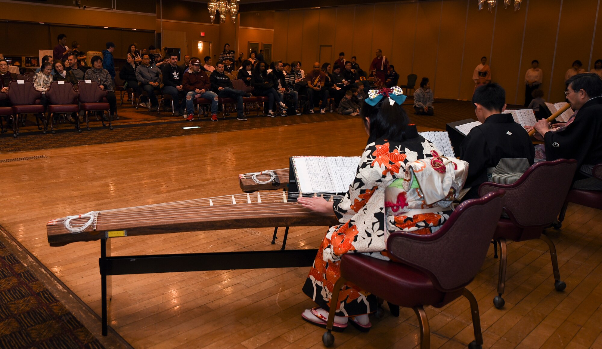The Wa-wa-wa Club performs with koto strings during the 32nd Annual Japan Day at Misawa Air Base, Japan, April 6, 2019. The Wa-wa-wa Club plays a variety of classical Japanese music with symphonic Japanese instruments across the Aomori prefecture. (U.S. Air Force photo by Branden Yamada)