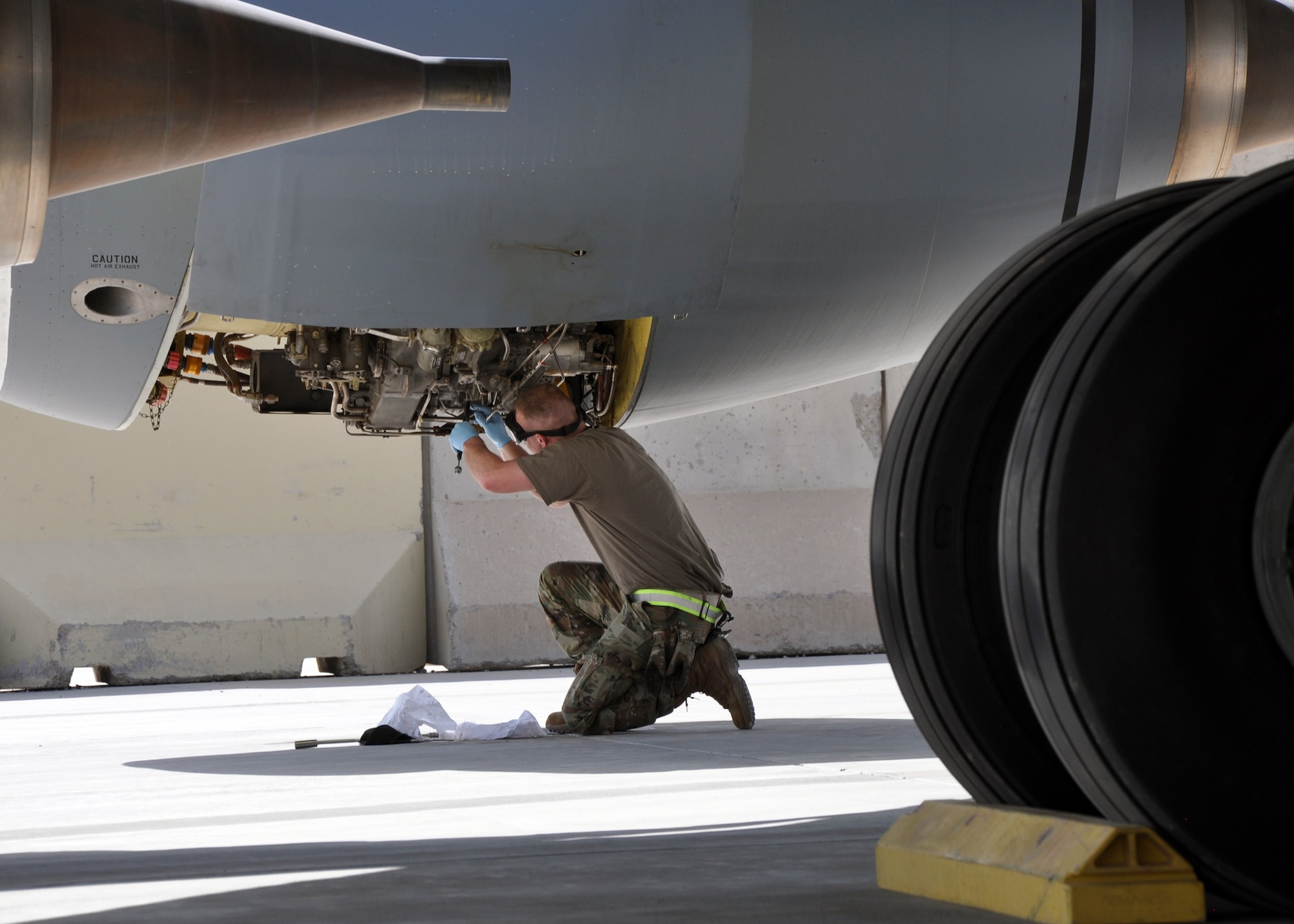An Airman from the 451st Expeditionary Aircraft Maintenance Squadron performs maintenance on a KC-135